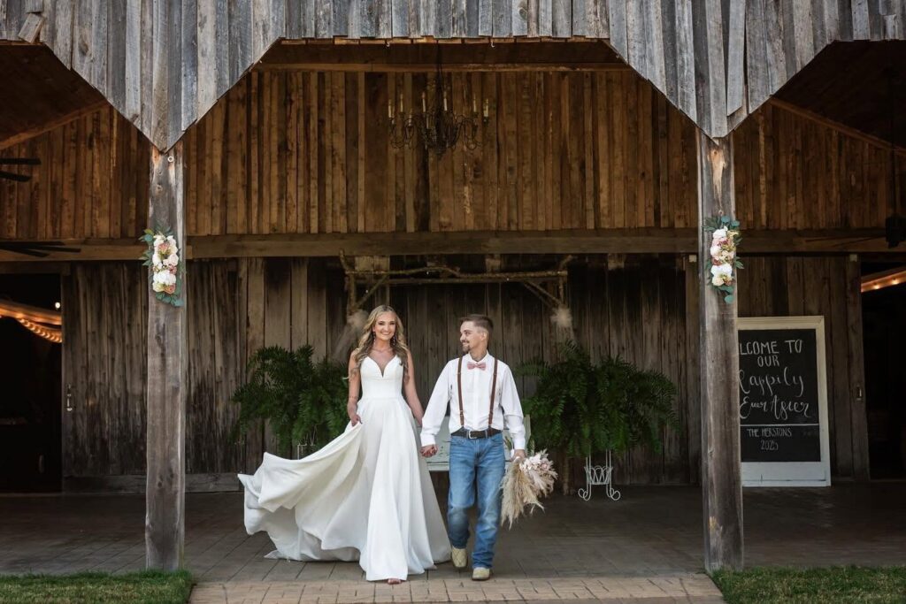 Bride and groom walking out of the barn doors at Ava's Place